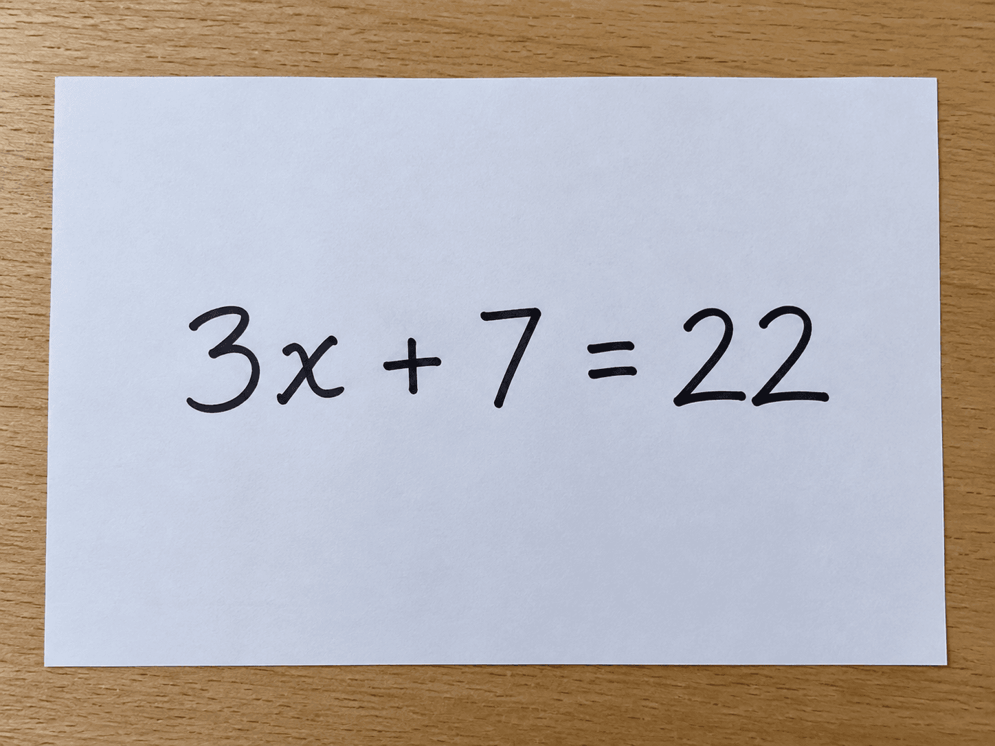 Clear photo of the handwritten linear equation 3x + 7 = 22