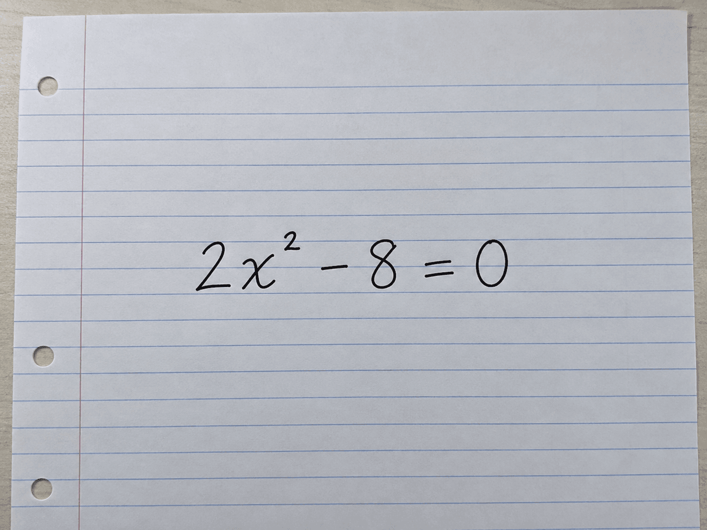 Clear photo of the handwritten quadratic equation 2x squared minus 8 equals 0